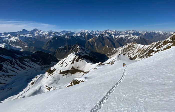 Skier descending through backcountry in the Central Andes (Santiago)